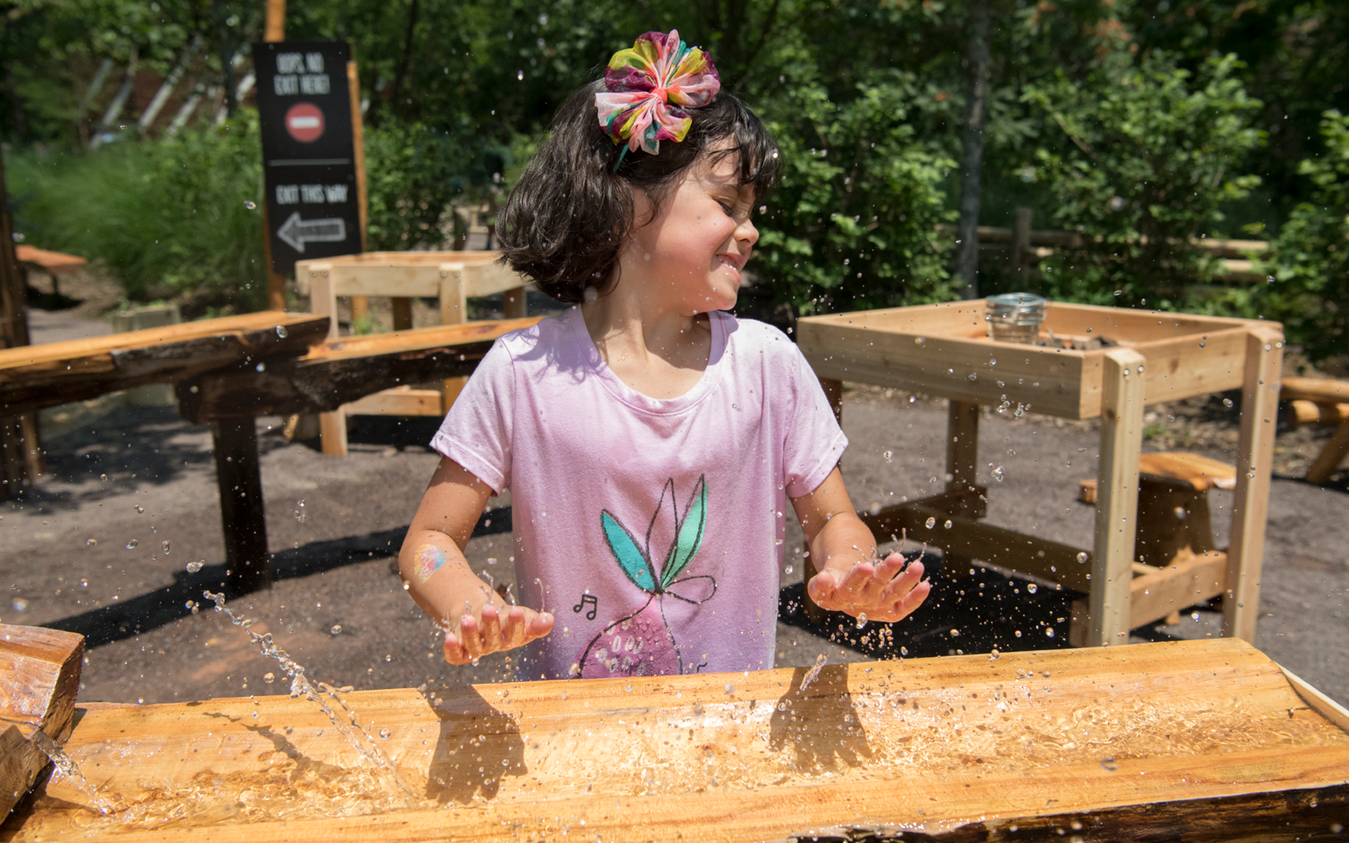 girl splashing water with hands at the nature trek